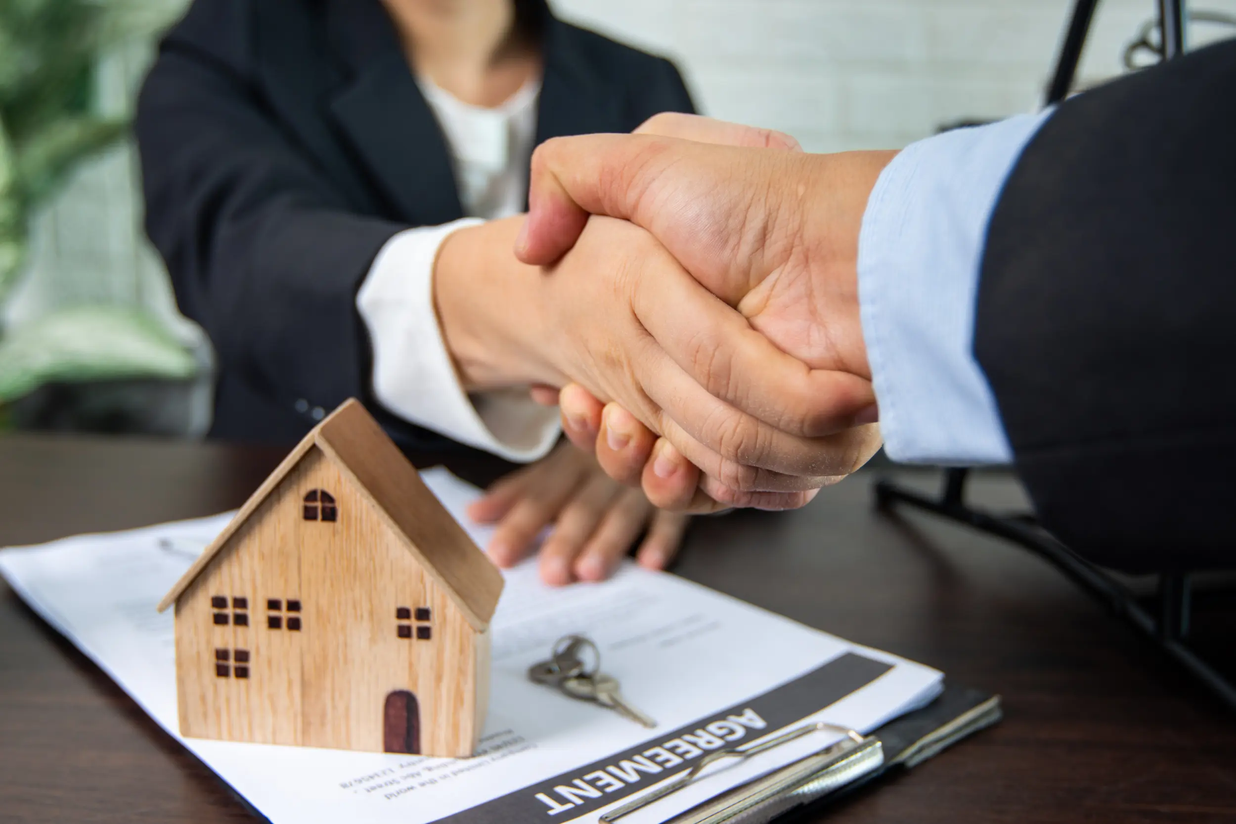 Real estate, handshake and sign contract concept, seller and buyer of home successful negotiate and achievement to agreement and shake hand together